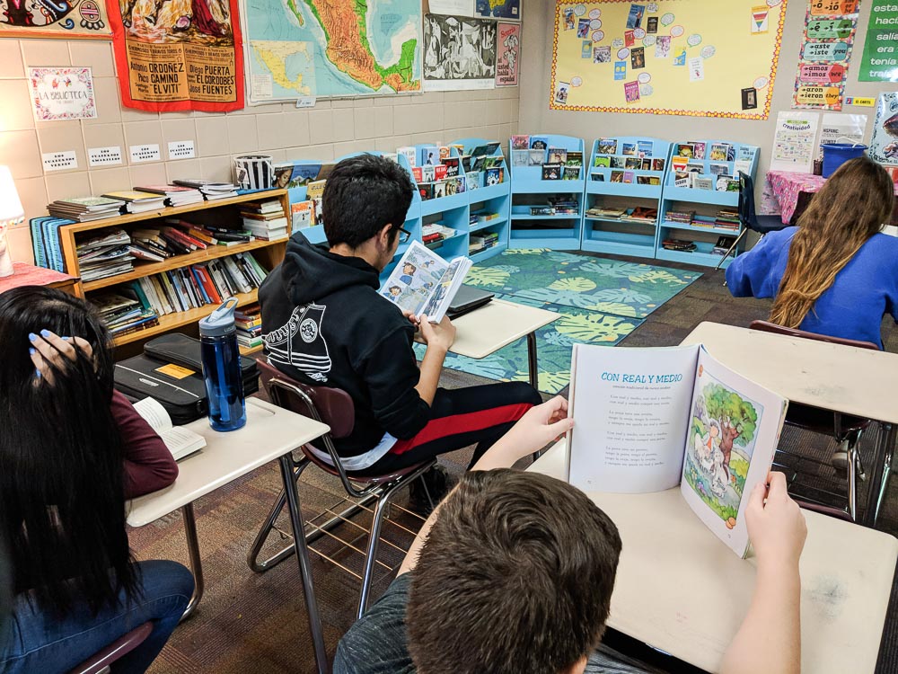 students reading in Spanish class